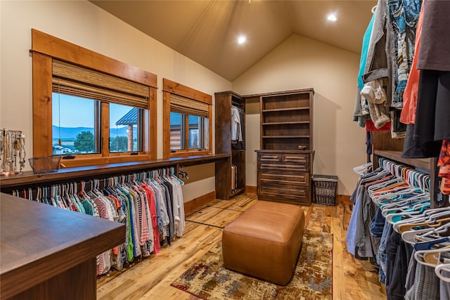 spacious closet featuring light hardwood / wood-style floors and vaulted ceiling