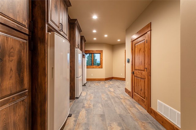 hall with tile patterned flooring