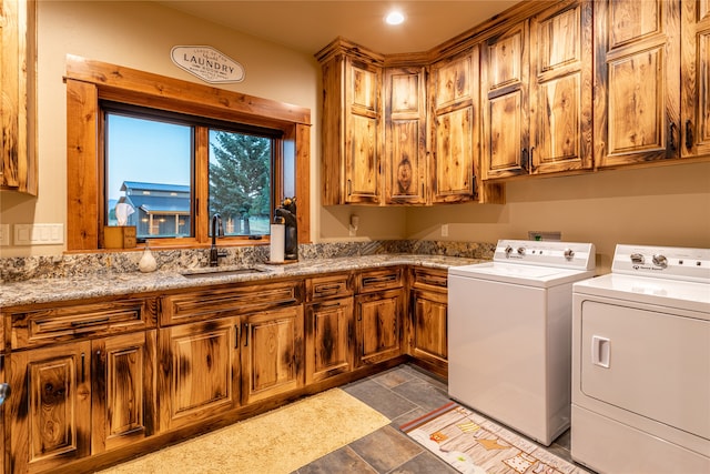 laundry room with light tile patterned flooring, sink, separate washer and dryer, and cabinets