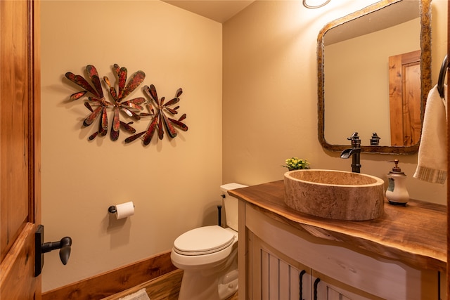 bathroom featuring hardwood / wood-style floors, toilet, and vanity