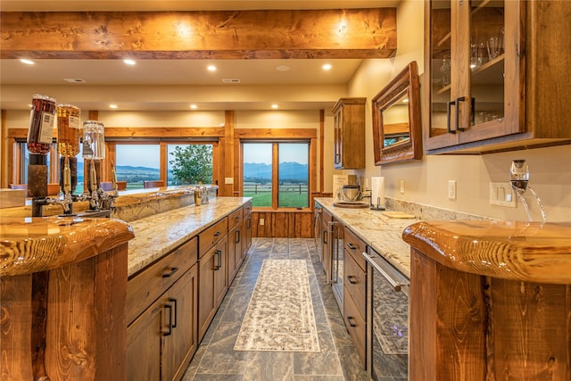 391 Skyline Dr, Hamilton, MT 59840 - kitchen with light stone countertops, brown cabinets, glass insert cabinets, dark stone finish flooring, and recessed lighting