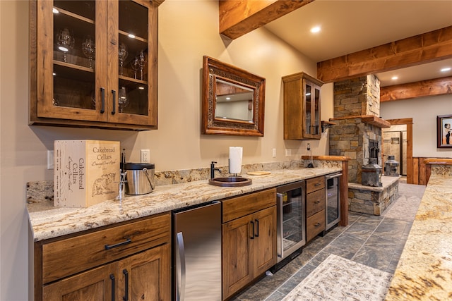 kitchen featuring beam ceiling, fridge, sink, and wine cooler