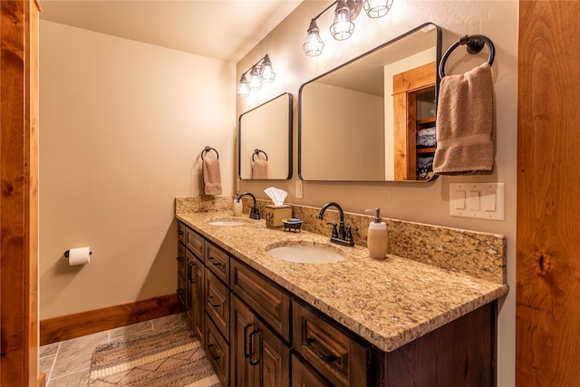 bathroom with tile patterned floors and double sink vanity