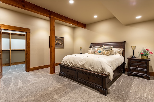 bedroom with beamed ceiling and carpet flooring