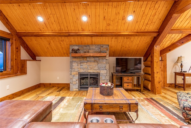 living room with vaulted ceiling with beams, a stone fireplace, wood ceiling, and wood-type flooring