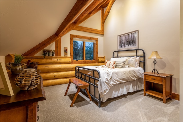 carpeted bedroom with beam ceiling