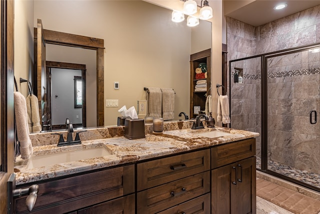 bathroom with walk in shower and dual bowl vanity