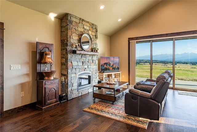 living room with high vaulted ceiling, a fireplace, dark hardwood / wood-style flooring, and a mountain view