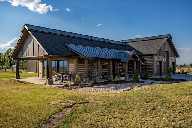 391 Skyline Dr, Hamilton, MT 59840 - back of house featuring a standing seam roof, a lawn, metal roof, and a shingled roof
