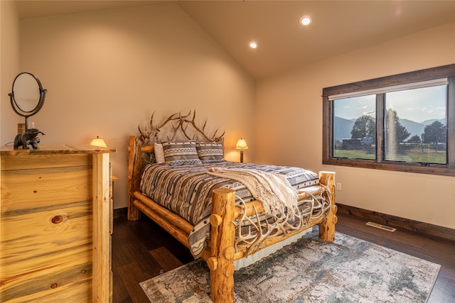 bedroom with dark hardwood / wood-style flooring and lofted ceiling