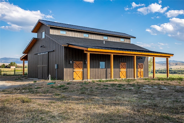 view of front of home featuring a mountain view and an outbuilding