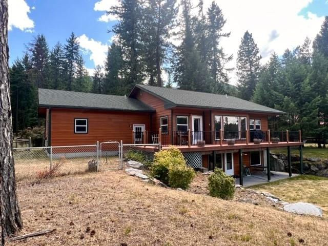 5 Osprey Dr E, Thompson Falls, MT 59873 - back of property with a deck, a gate, and a patio