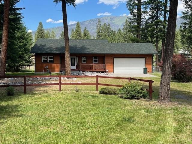 5 Osprey Dr E, Thompson Falls, MT 59873 - ranch-style house featuring an attached garage, a mountain view, and covered porch