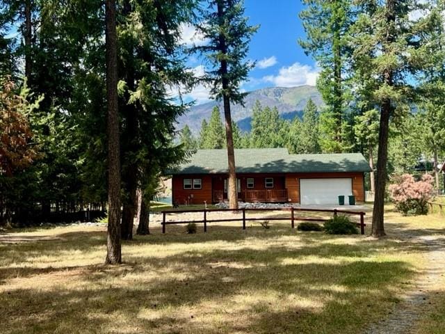 5 Osprey Dr E, Thompson Falls, MT 59873 - view of front of house with a garage and a mountain view
