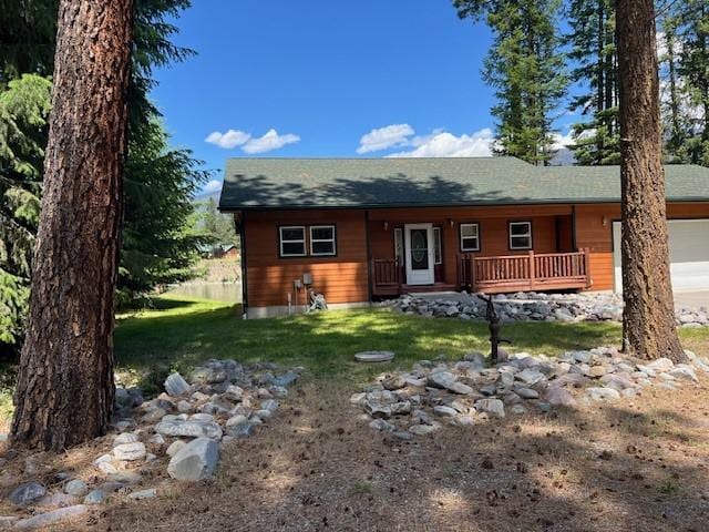 5 Osprey Dr E, Thompson Falls, MT 59873 - view of front facade with a porch, an attached garage, a front lawn, and driveway