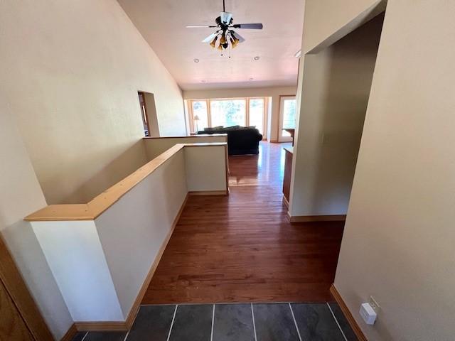 5 Osprey Dr E, Thompson Falls, MT 59873 - hallway featuring lofted ceiling, dark wood-style floors, and an upstairs landing
