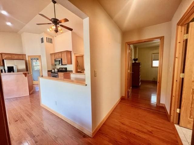 5 Osprey Dr E, Thompson Falls, MT 59873 - kitchen featuring stainless steel appliances, light wood-type flooring, ceiling fan, brown cabinetry, and light countertops