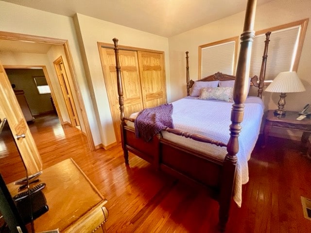 bedroom with a closet and hardwood / wood-style flooring