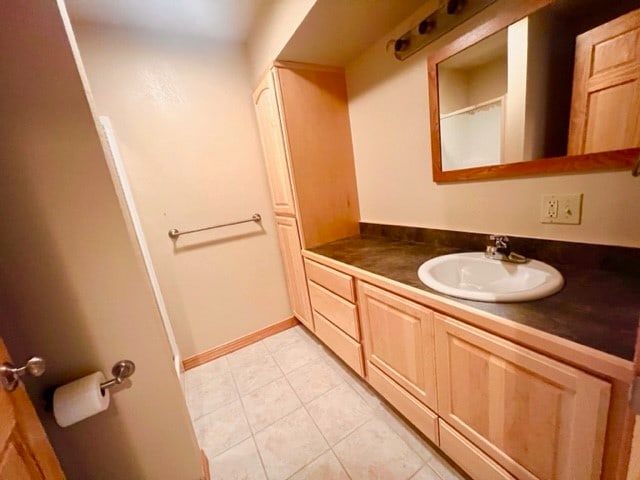 bathroom with tile floors and vanity