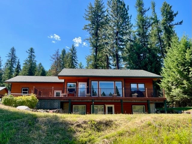 rear view of property with a wooden deck