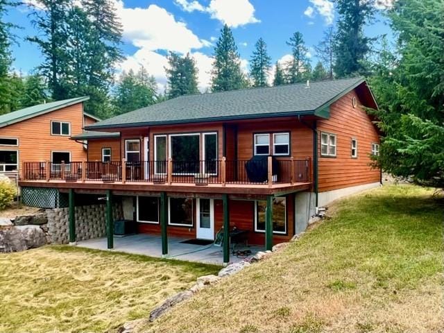 5 Osprey Dr E, Thompson Falls, MT 59873 - back of property with a patio, a lawn, and a deck