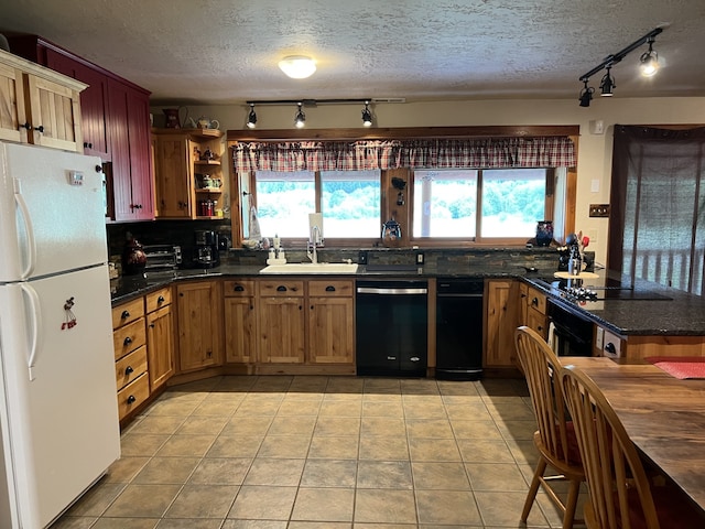 kitchen featuring decorative backsplash, sink, a healthy amount of sunlight, and black appliances