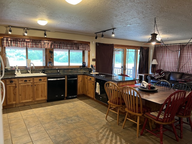 kitchen with sink, kitchen peninsula, a textured ceiling, light tile patterned floors, and black appliances