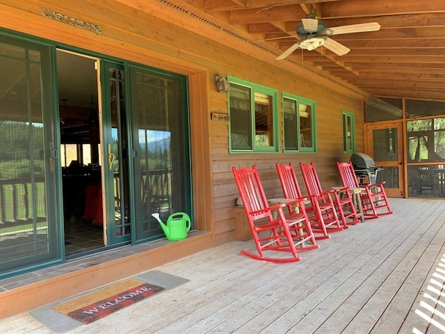 wooden terrace featuring area for grilling and ceiling fan