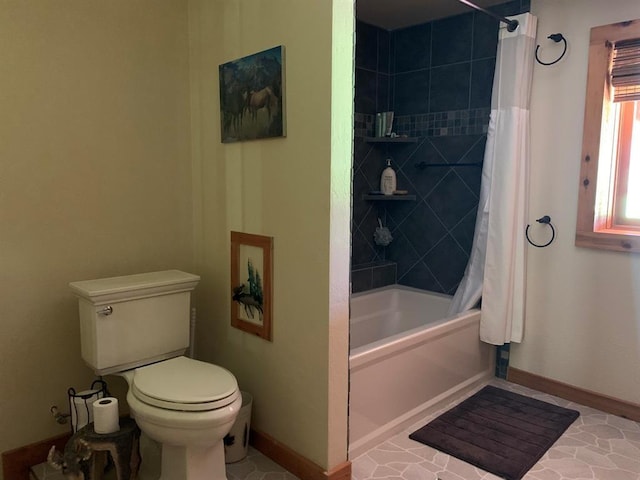 bathroom with tile patterned flooring, toilet, and shower / tub combo