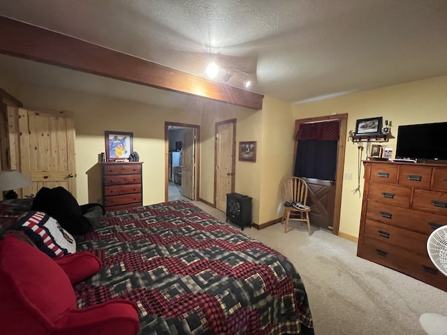 bedroom with a textured ceiling and light carpet