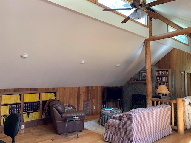 living room with ceiling fan, lofted ceiling, and light wood-type flooring