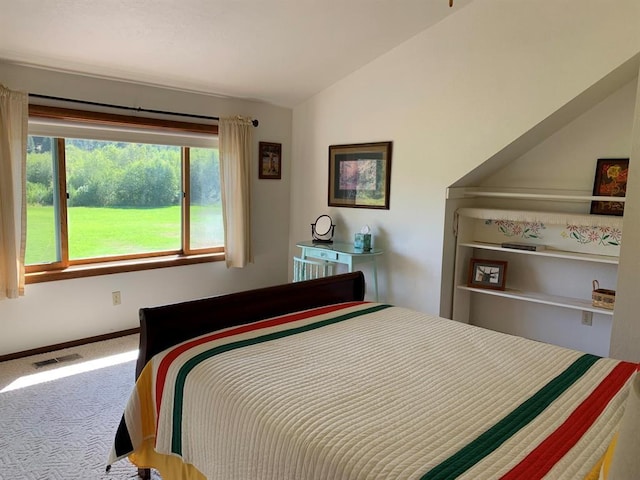 bedroom with carpet and lofted ceiling