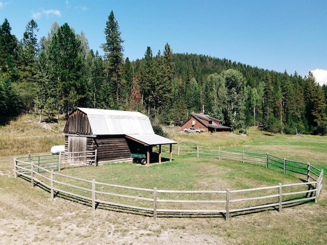 exterior space with a rural view and an outdoor structure