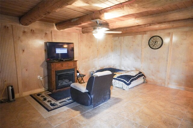 tiled living room featuring wooden ceiling, ceiling fan, wood walls, and beamed ceiling