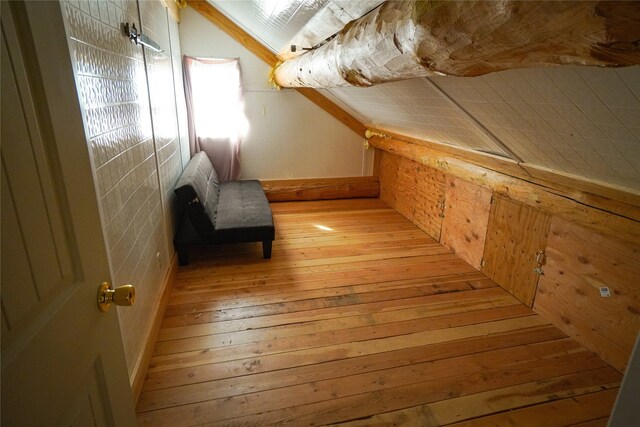 bonus room featuring lofted ceiling and light wood-type flooring