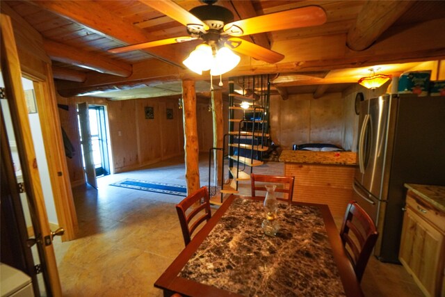 tiled dining space featuring wooden ceiling, wooden walls, ceiling fan, and beamed ceiling