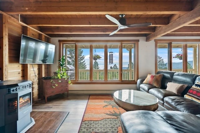 living room featuring ceiling fan, a baseboard radiator, wooden ceiling, dark wood-type flooring, and beamed ceiling