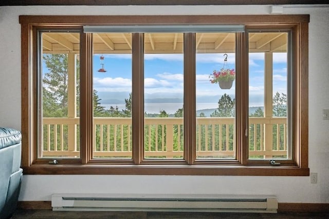 doorway with a baseboard heating unit and baseboards