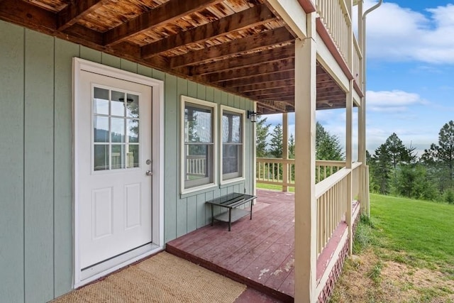 wooden terrace featuring a lawn