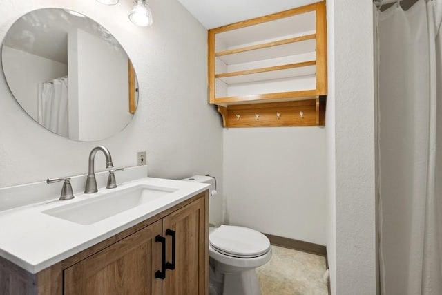 full bathroom featuring toilet, baseboards, and vanity