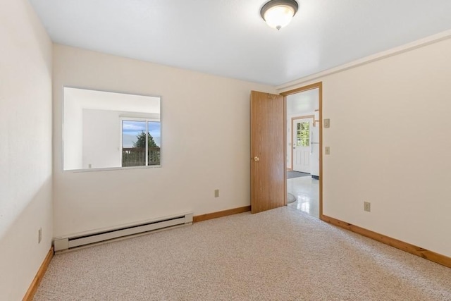 carpeted spare room featuring baseboards and baseboard heating