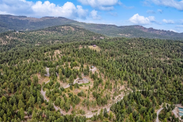 drone / aerial view featuring a mountain view and a view of trees