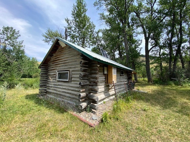 view of outdoor structure with a lawn