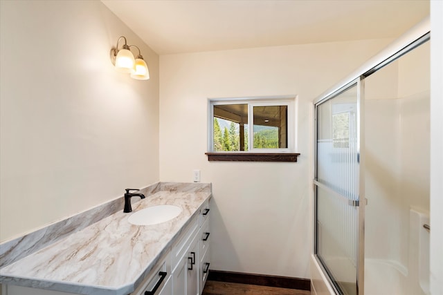 bathroom with enclosed tub / shower combo and vanity