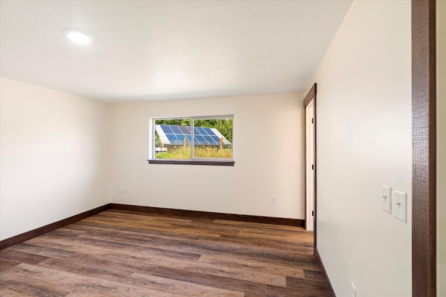 spare room featuring dark hardwood / wood-style floors