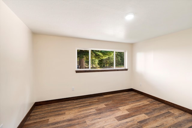 spare room with dark hardwood / wood-style flooring