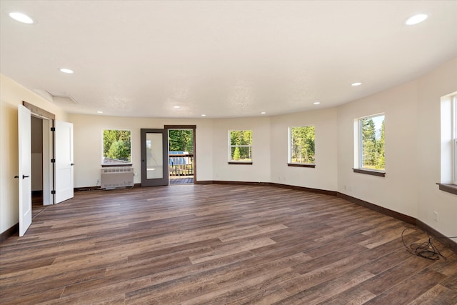 spare room with radiator and dark hardwood / wood-style flooring