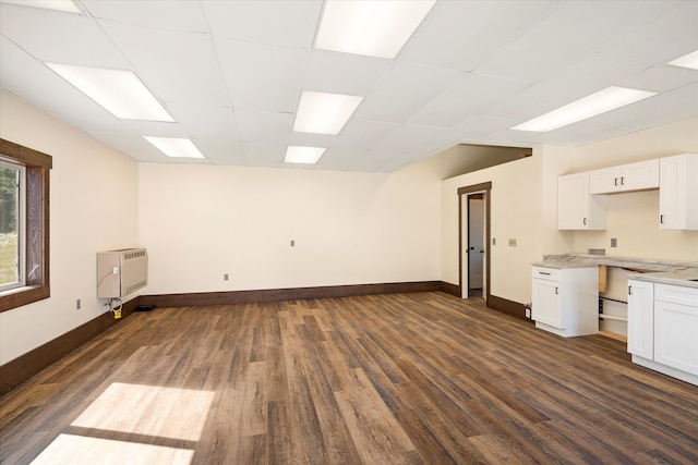 kitchen featuring dark hardwood / wood-style flooring and white cabinetry