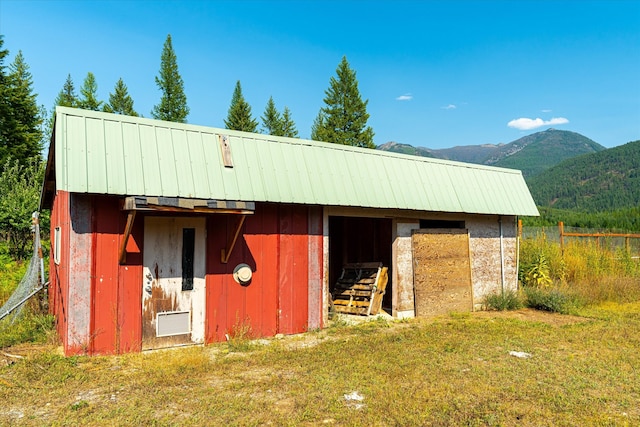 view of stable with a yard, an outdoor structure, and a mountain view