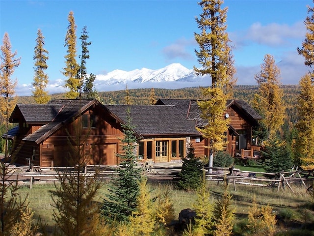 back of house with a mountain view and french doors